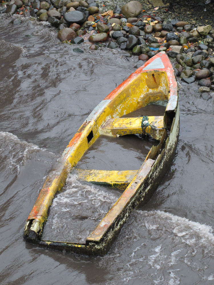 Dead boat lying on the shore