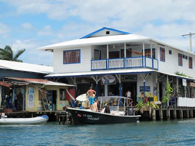 Surfers arrive by boat at Bocas Town